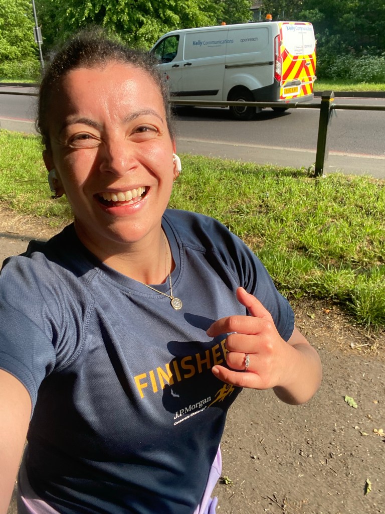 Girl running along a road smiling at the camera